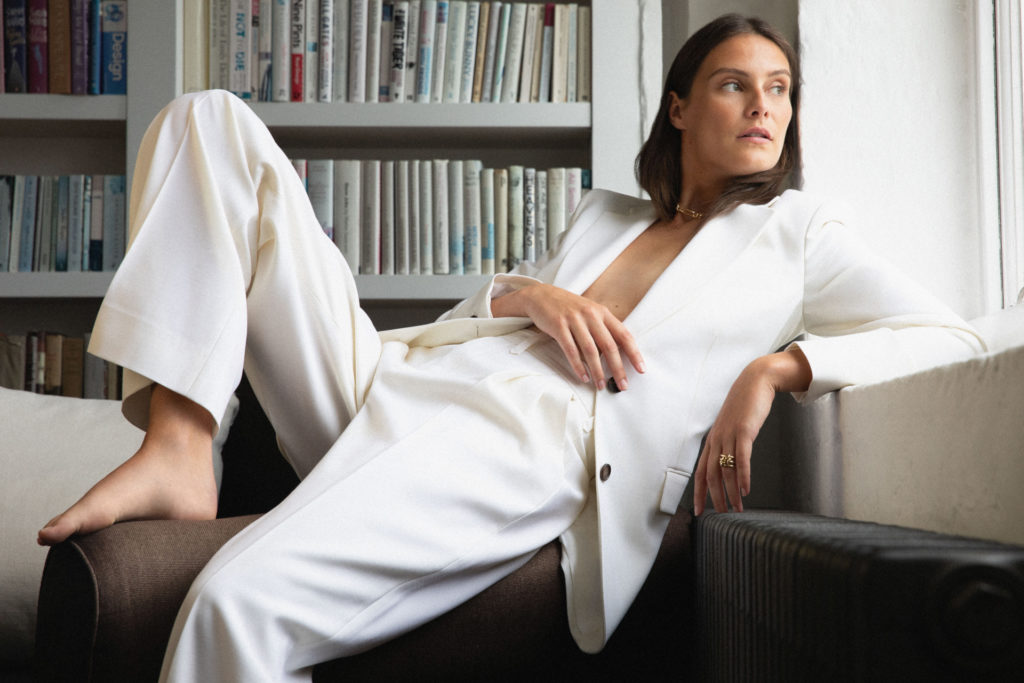 Daisy Knatchbull reclining in white suit