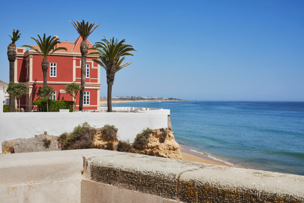 Red villa overlooking ocean