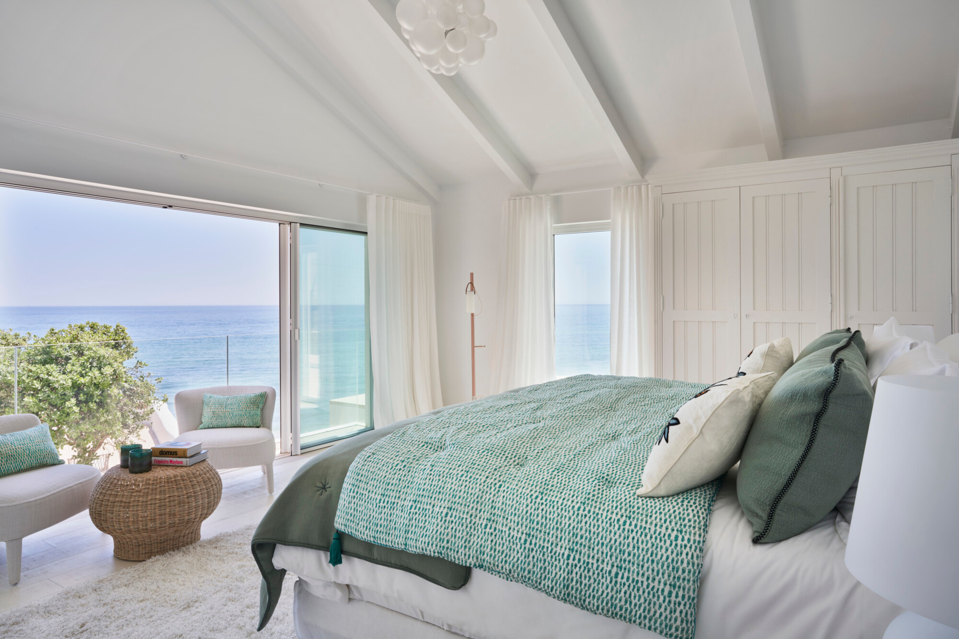 Bedroom with white walls and blue sheets