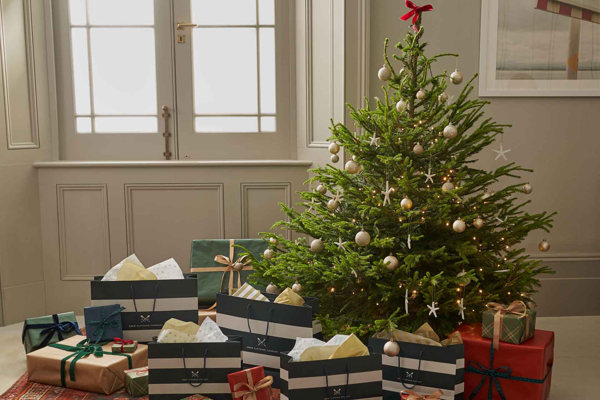 Christmas tree with Crew Clothing bags below