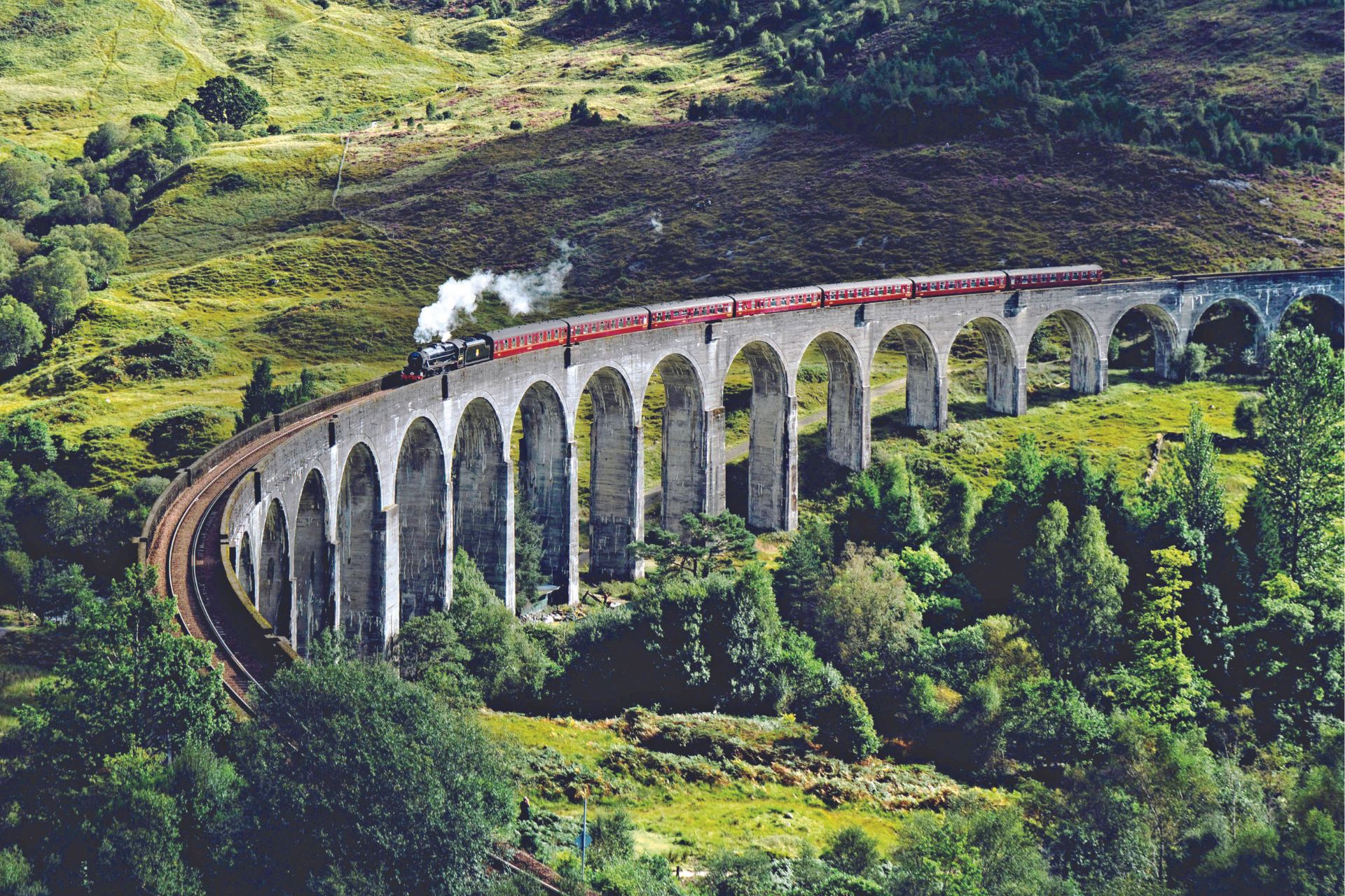 Aerial view of Glenfinnan Viaduct with a train going by,