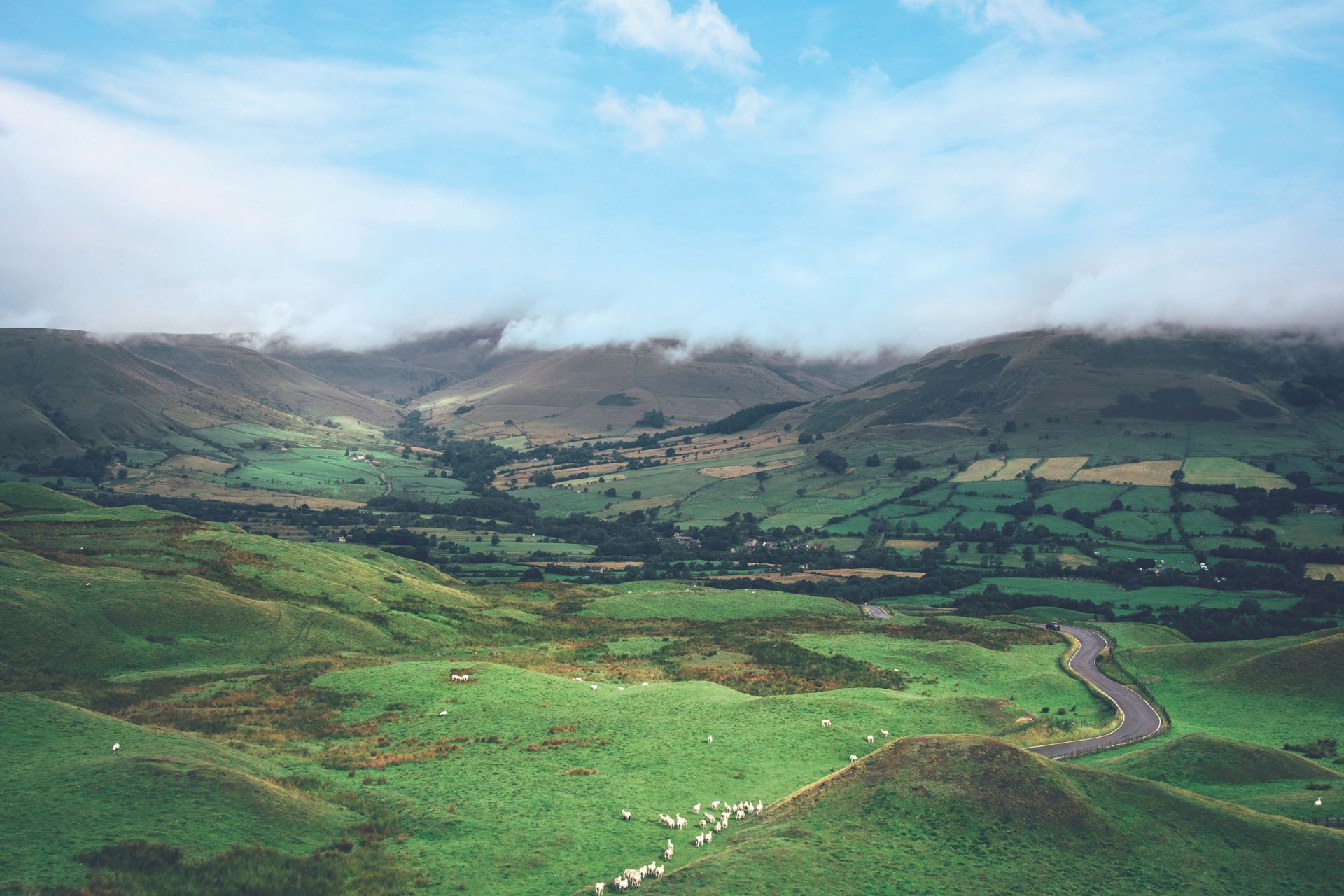 Hills and valleys with clouds above