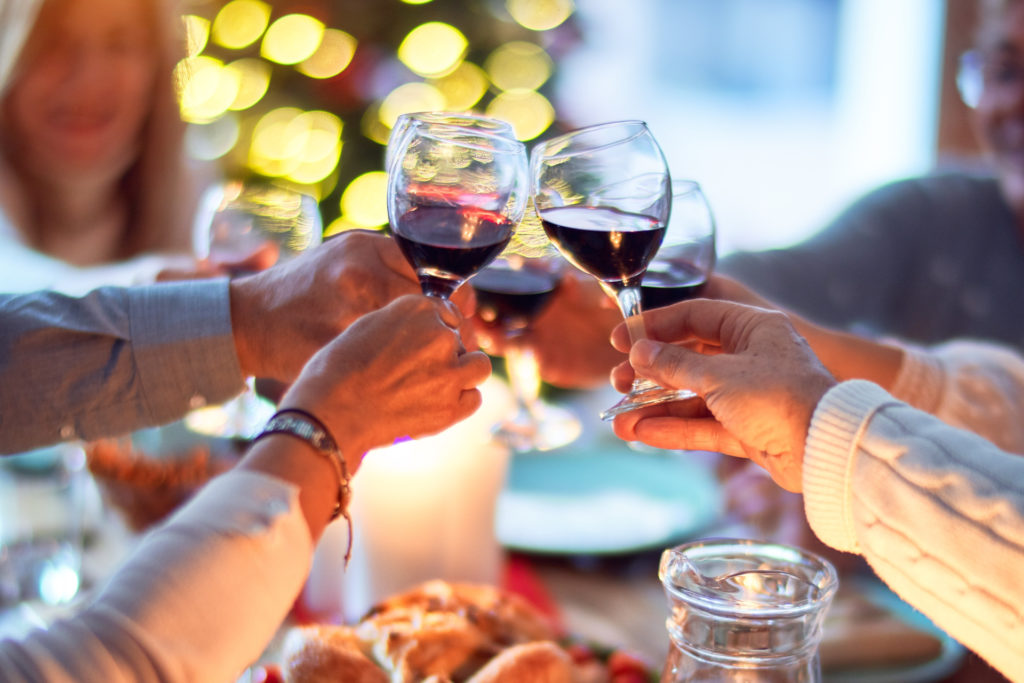 Close up of hands toasting glasses of wine