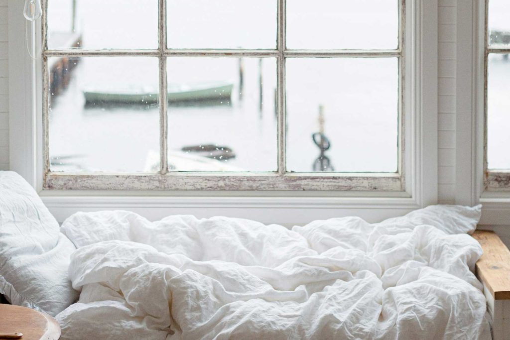 unmade bed by the window