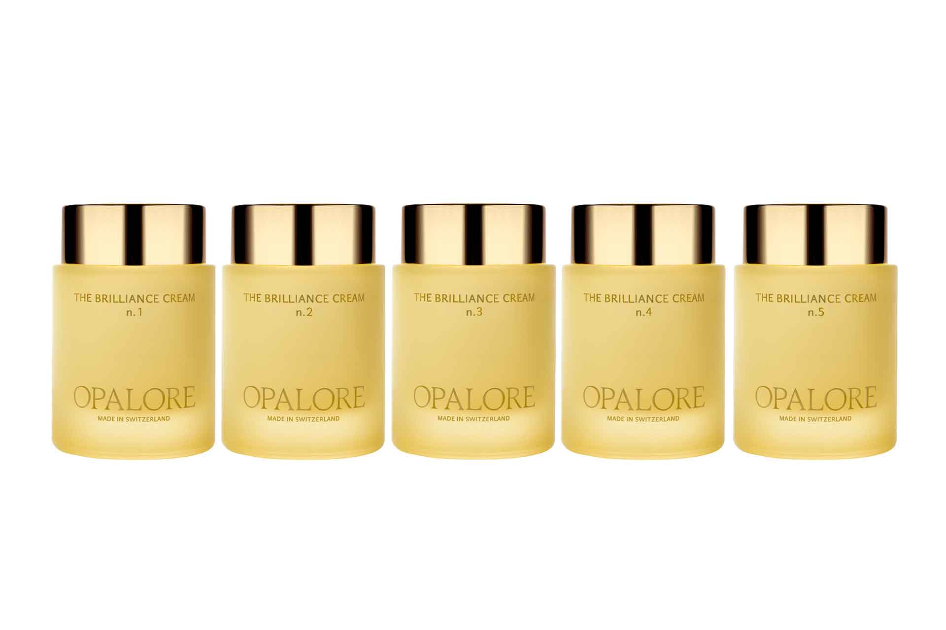 A line of yellow bottles with gold lids