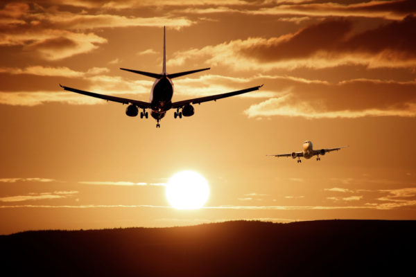 Two planes against a sunset sky