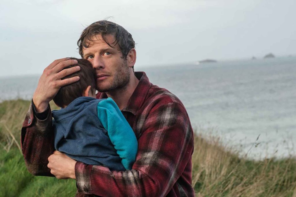James Norton holding a toddler in ITV's new drama, Playing Nice