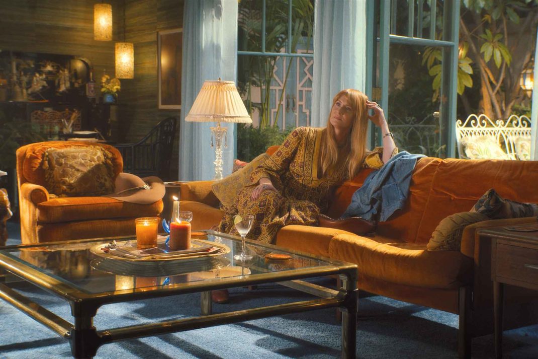 Woman reclining on an orange sofa