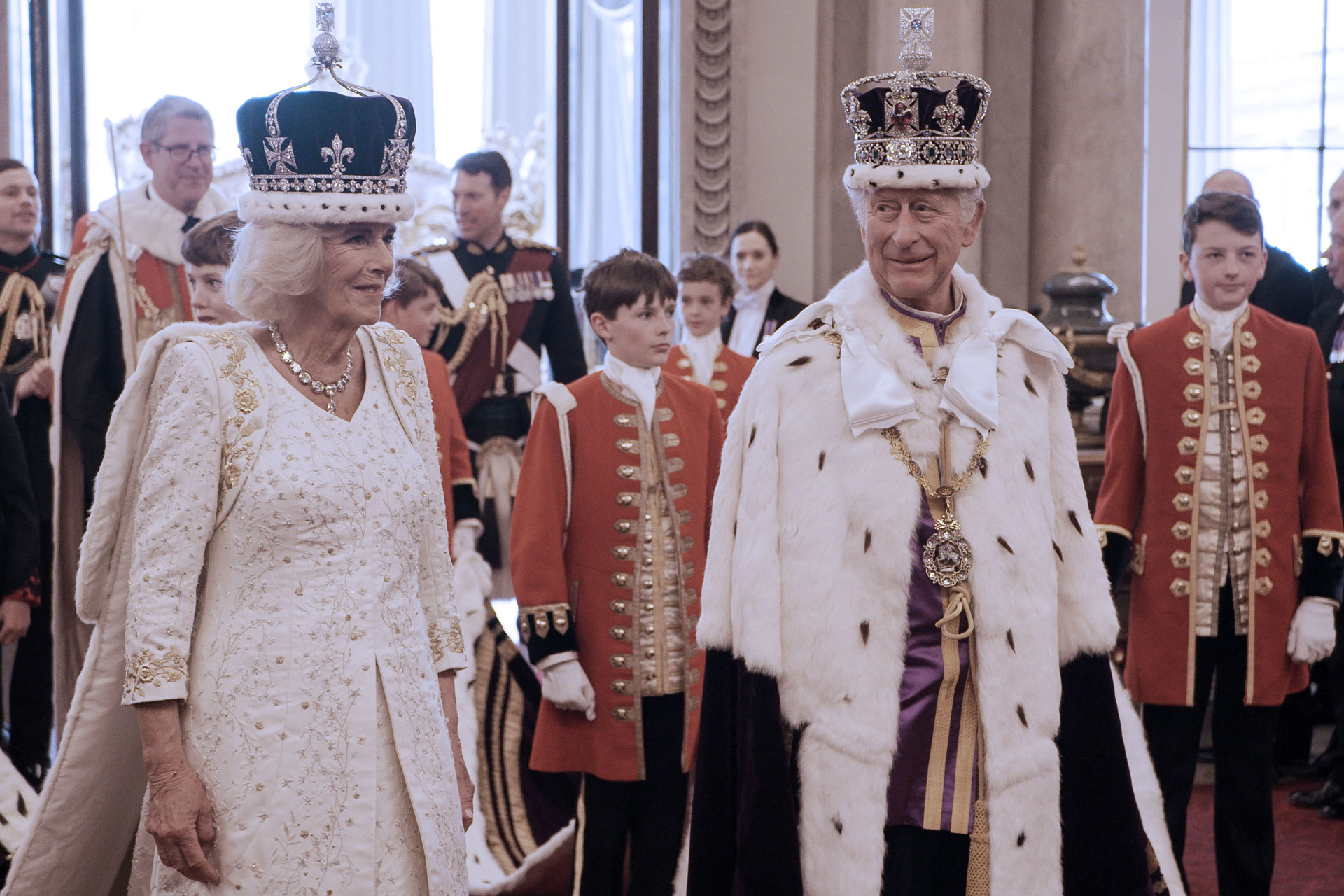King Charles III and Queen Camilla in Coronation gowns and crowns at Buckingham Palace on Coronation day