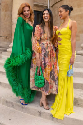 Women in colourful dresses stood on steps | best rental platforms