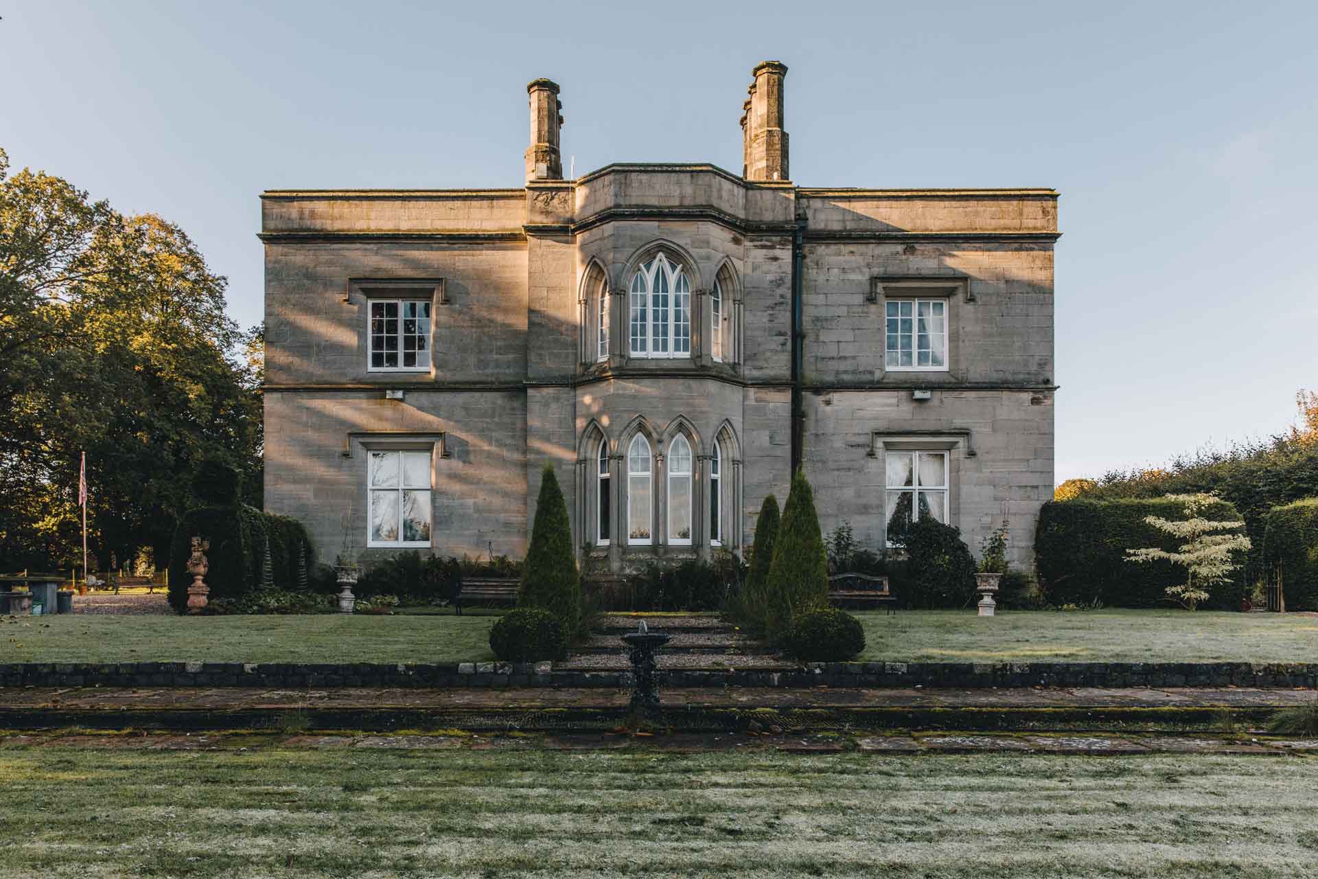 Exterior of Victorian country manor with lawns in front