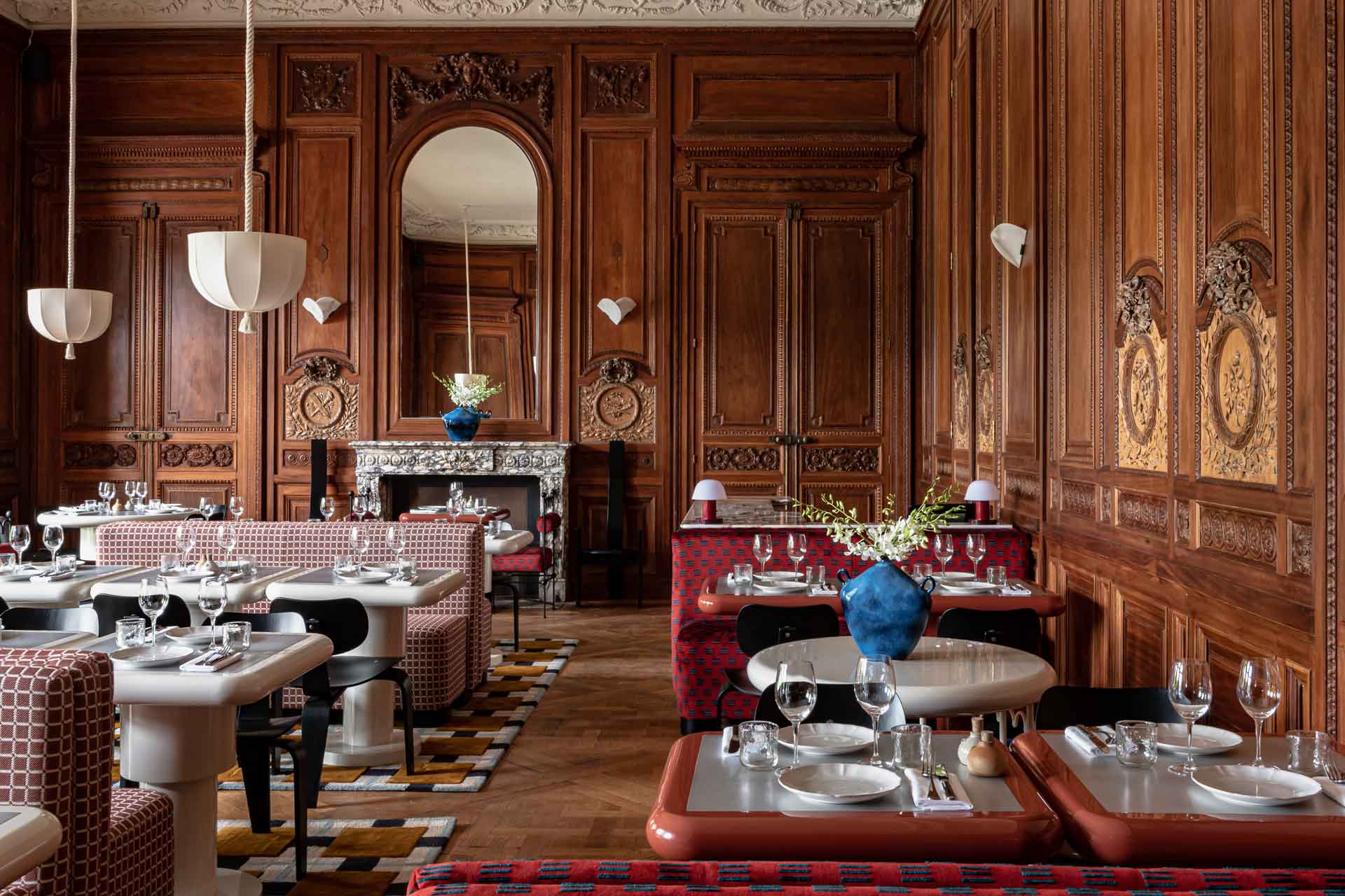 Wood-panelled dining room with red banquette seating