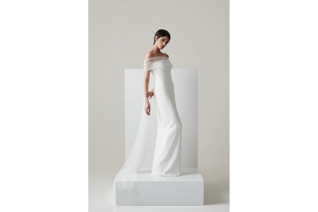 Woman in pearl-dotted wedding dress