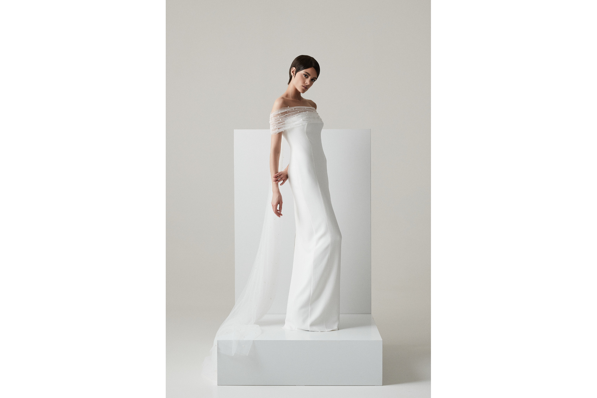 Woman in pearl-dotted wedding dress