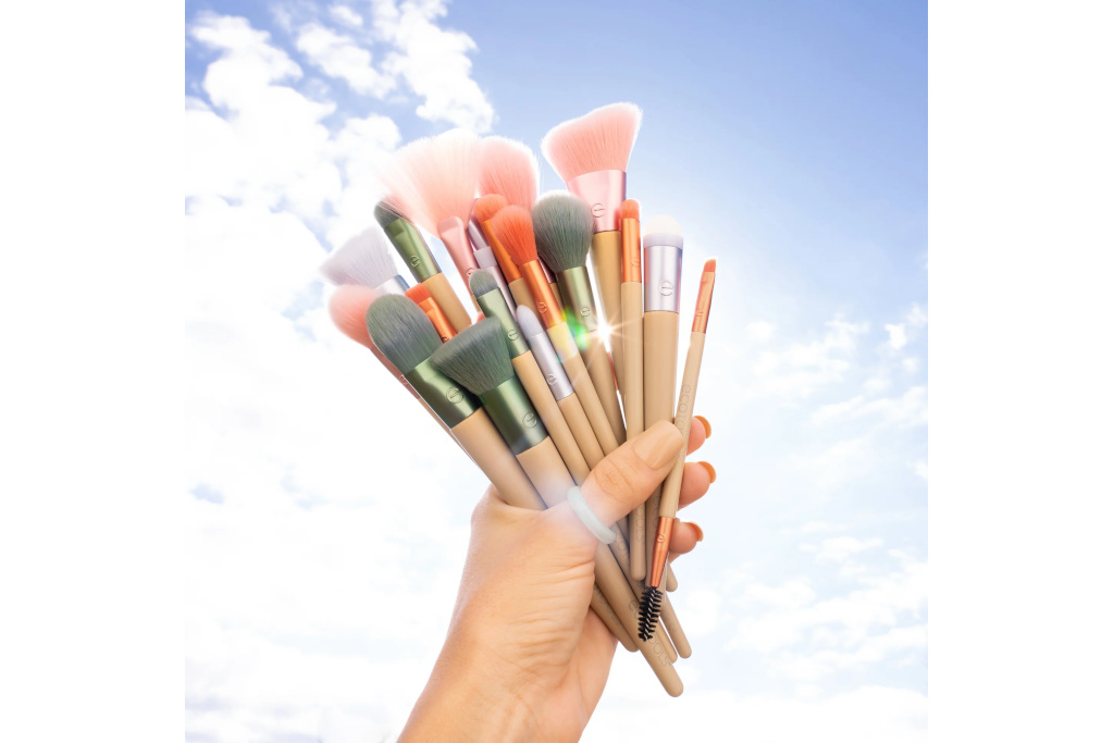 Hand holding makeup brushes