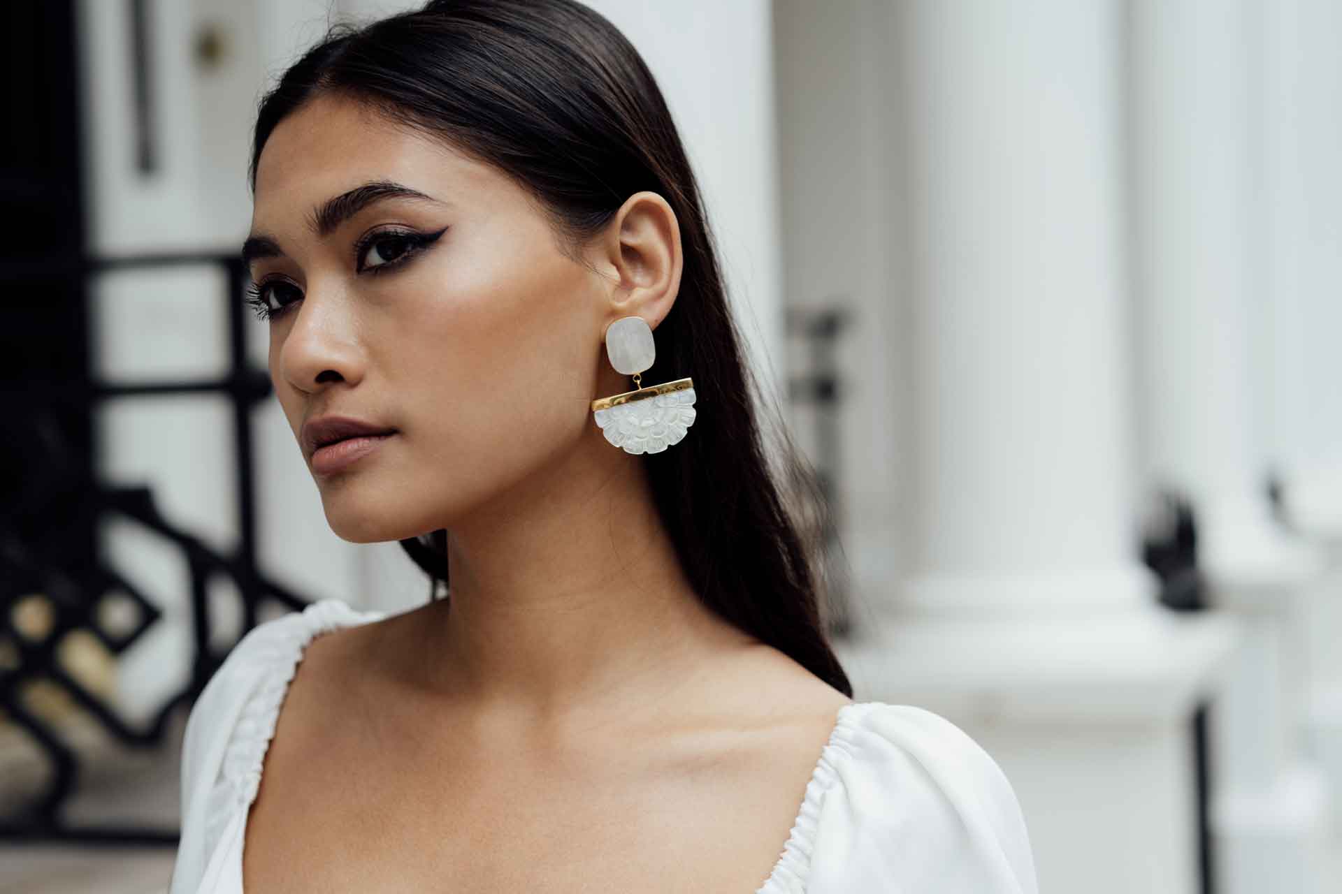 Model wearing fan-shaped pearl earrings