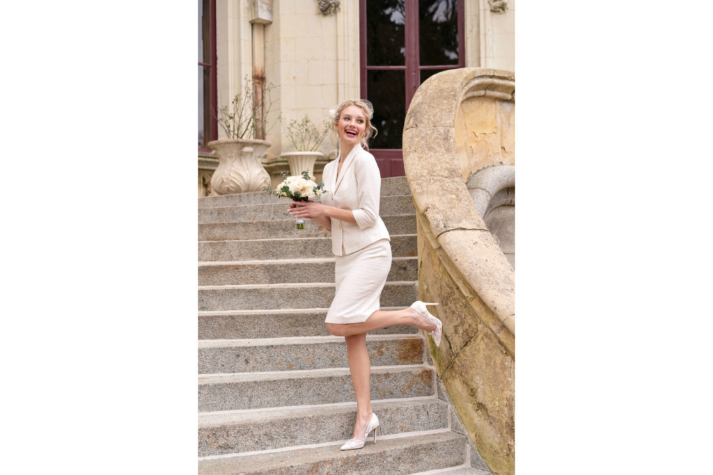 Woman in white tweed skirt suit