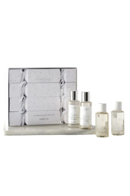 Bottles of body fragrance with white crackers