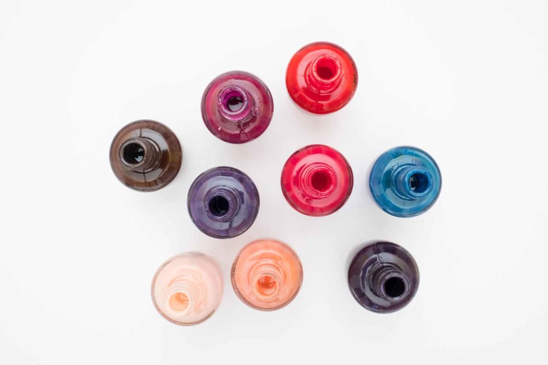 Open jars of nail polish photographed from above