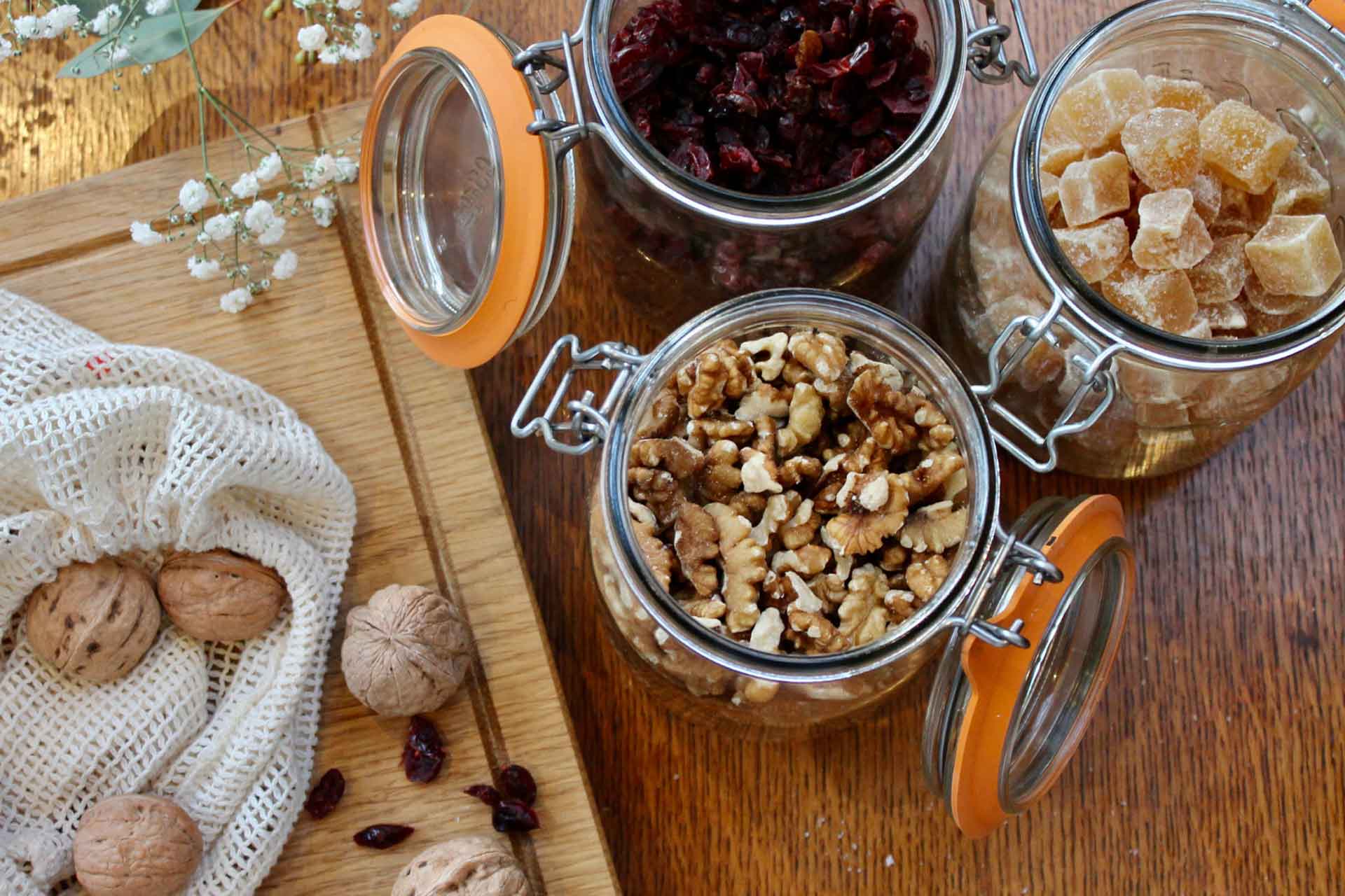 jars of dried foods with chopping board beside them