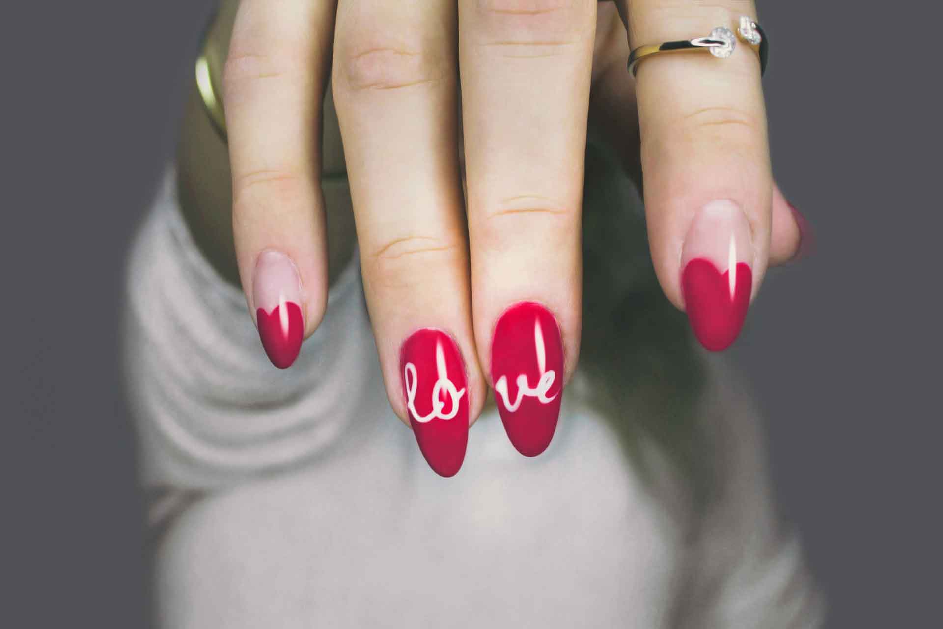 Red nails with 'love' design in white