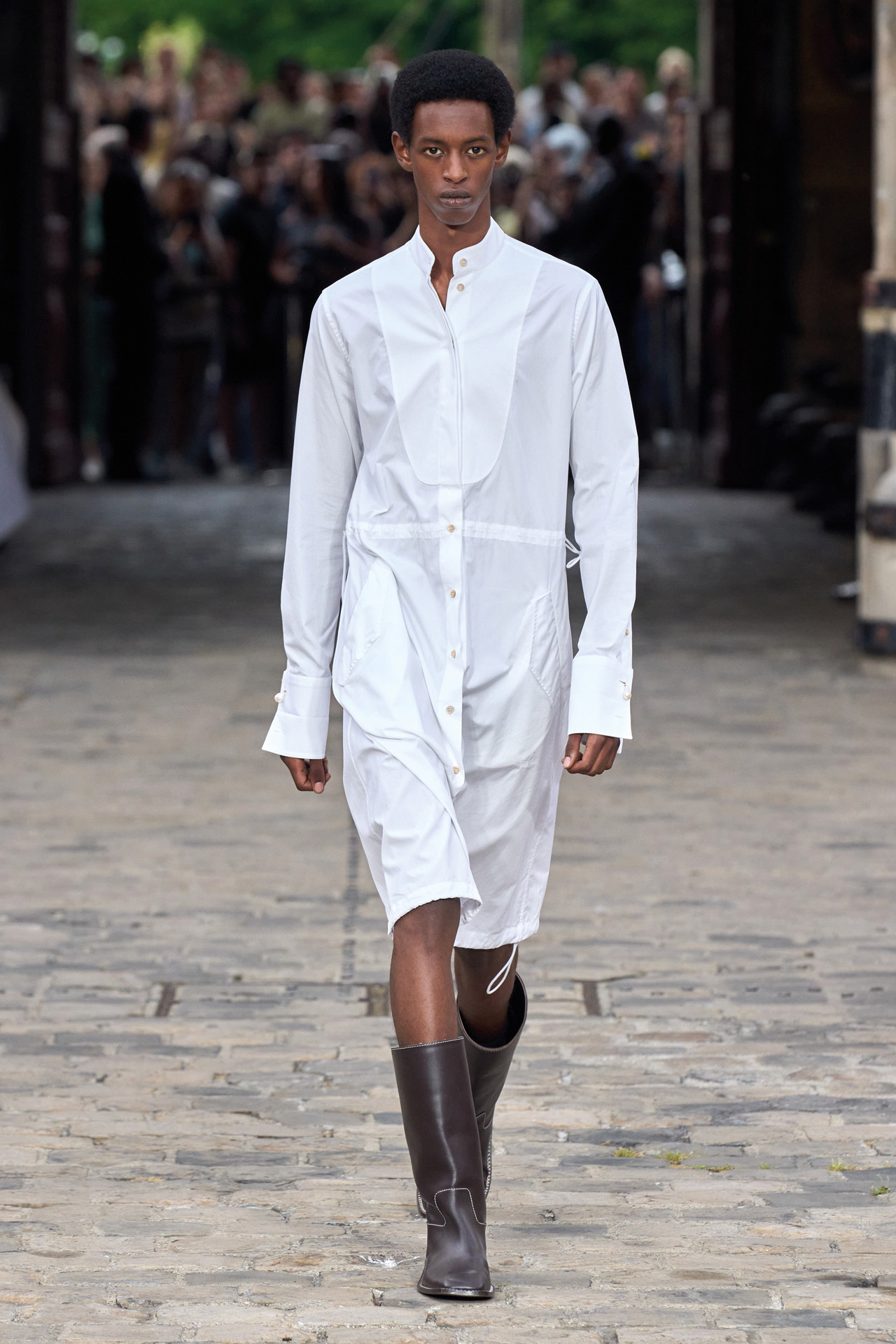 A Black man walking down a catwalk