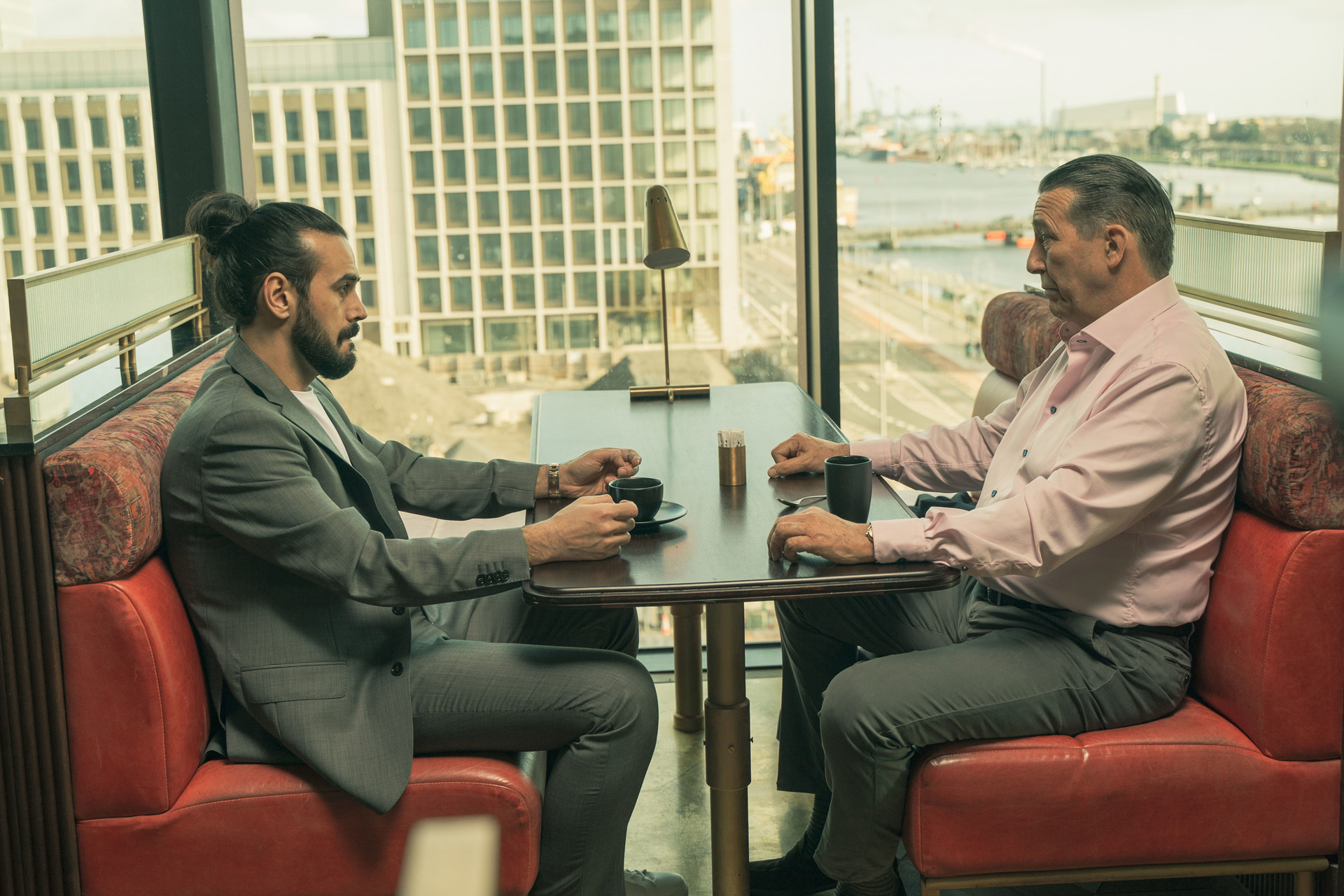 Cenk Batuk (BAMSHAD ABDEDI-AMIN), Eamon Cunningham (CIARAN HINDS) in Kin