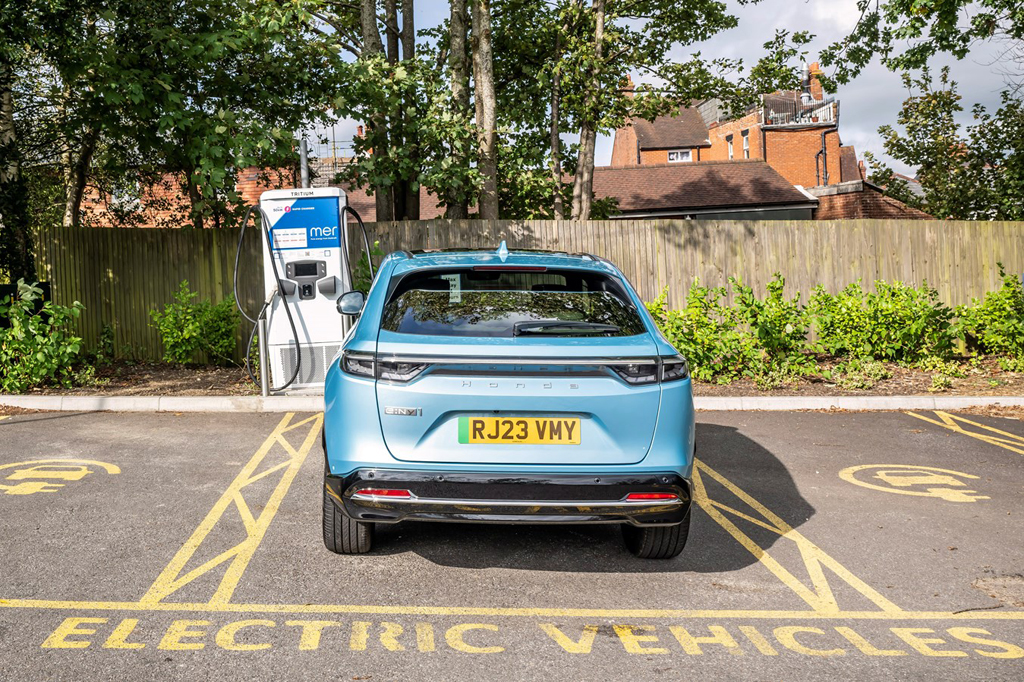 The rear of the Honda e:Ny1 in a charging bay