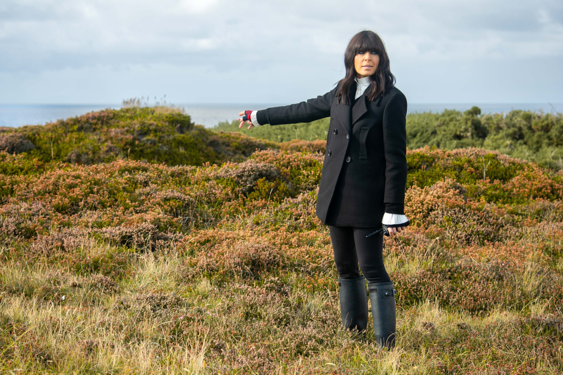 Claudia Winkleman in black jacket and white top