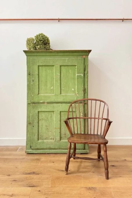 Green cupboard and wooden chair