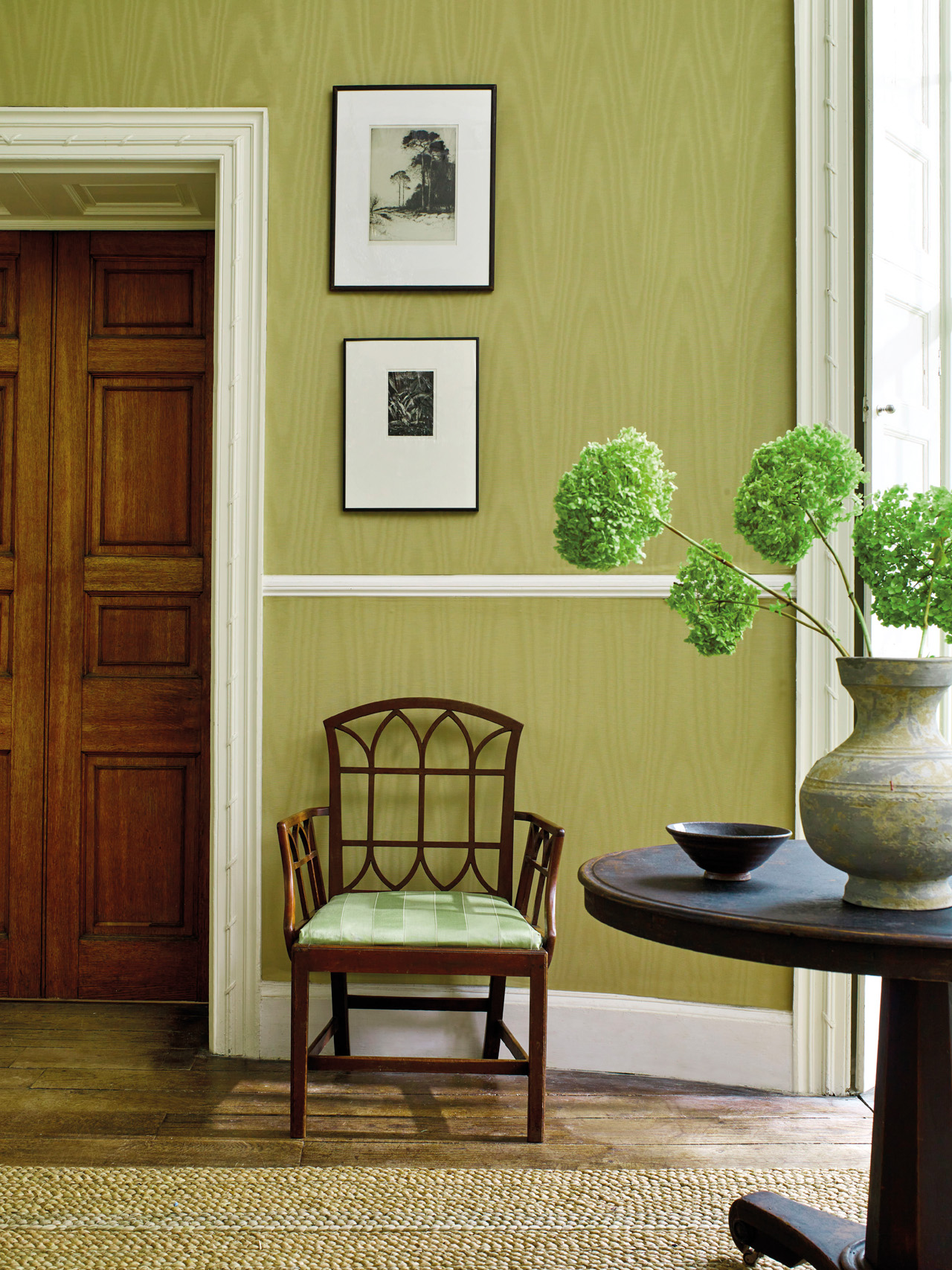 A chair against a lemon green wall