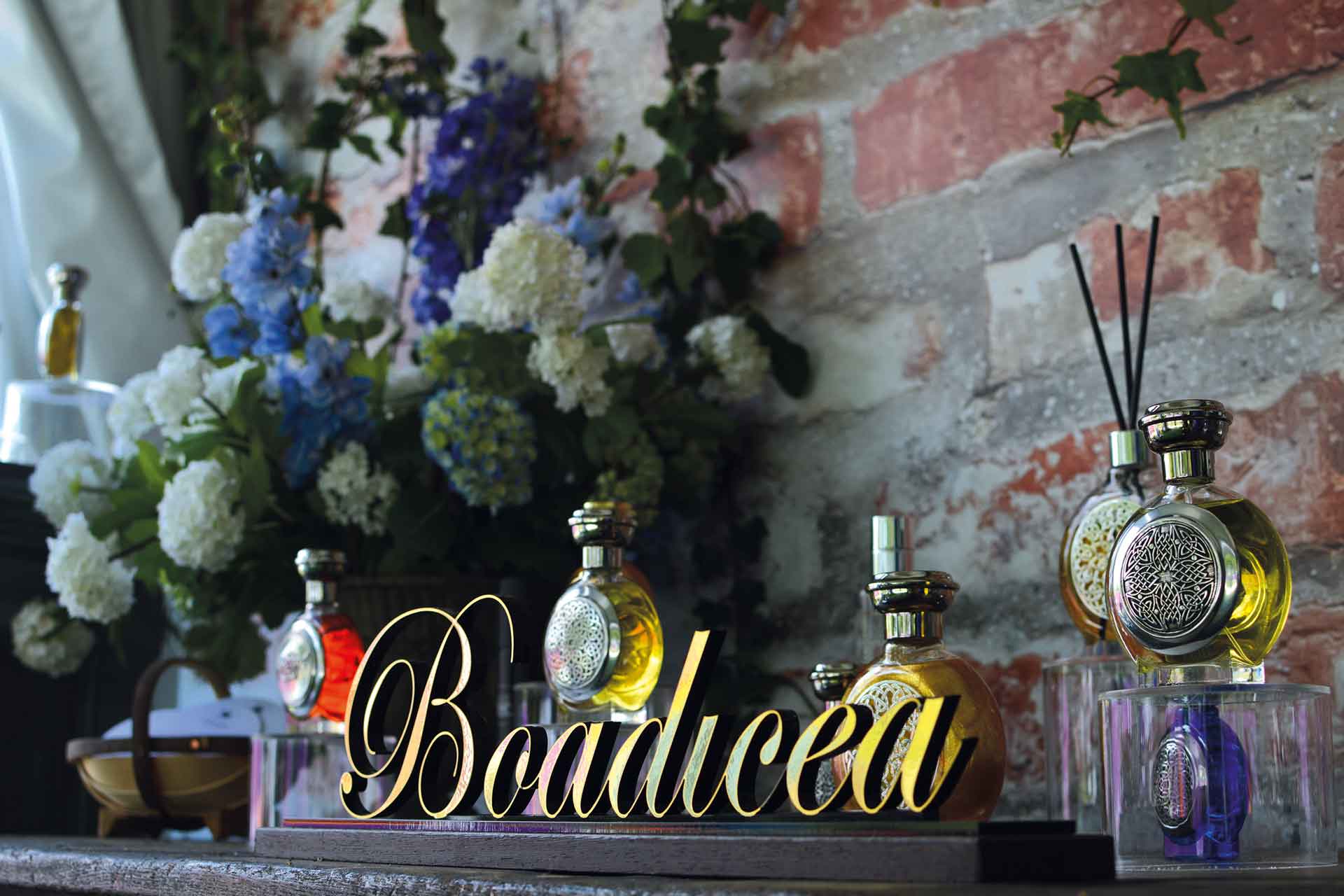 Boadicea the Victorious perfume bottle surrounded by bouquets of flowers
