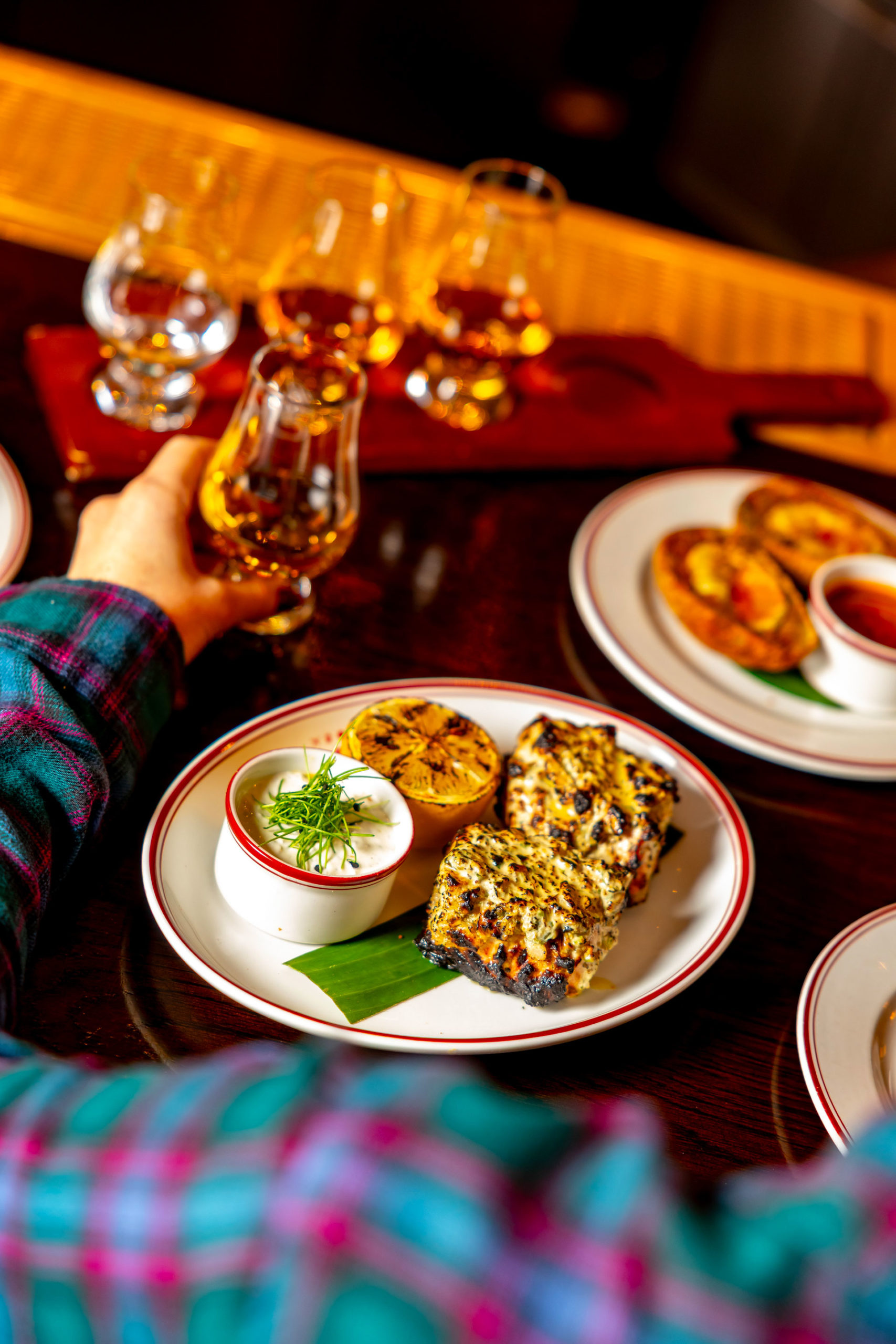 A plate of paneer with drams of whisky