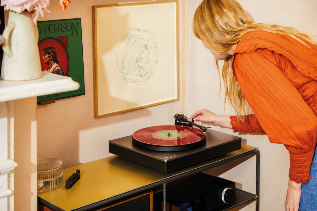 Woman setting up record player