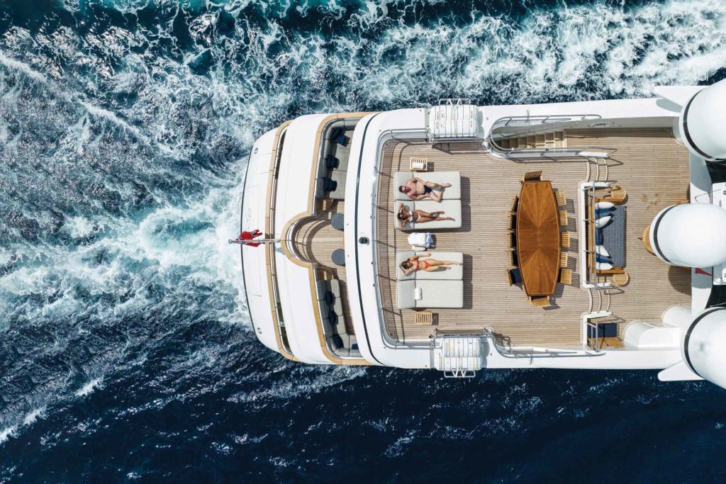 Aerial view of people reclining on the top deck of a yacht