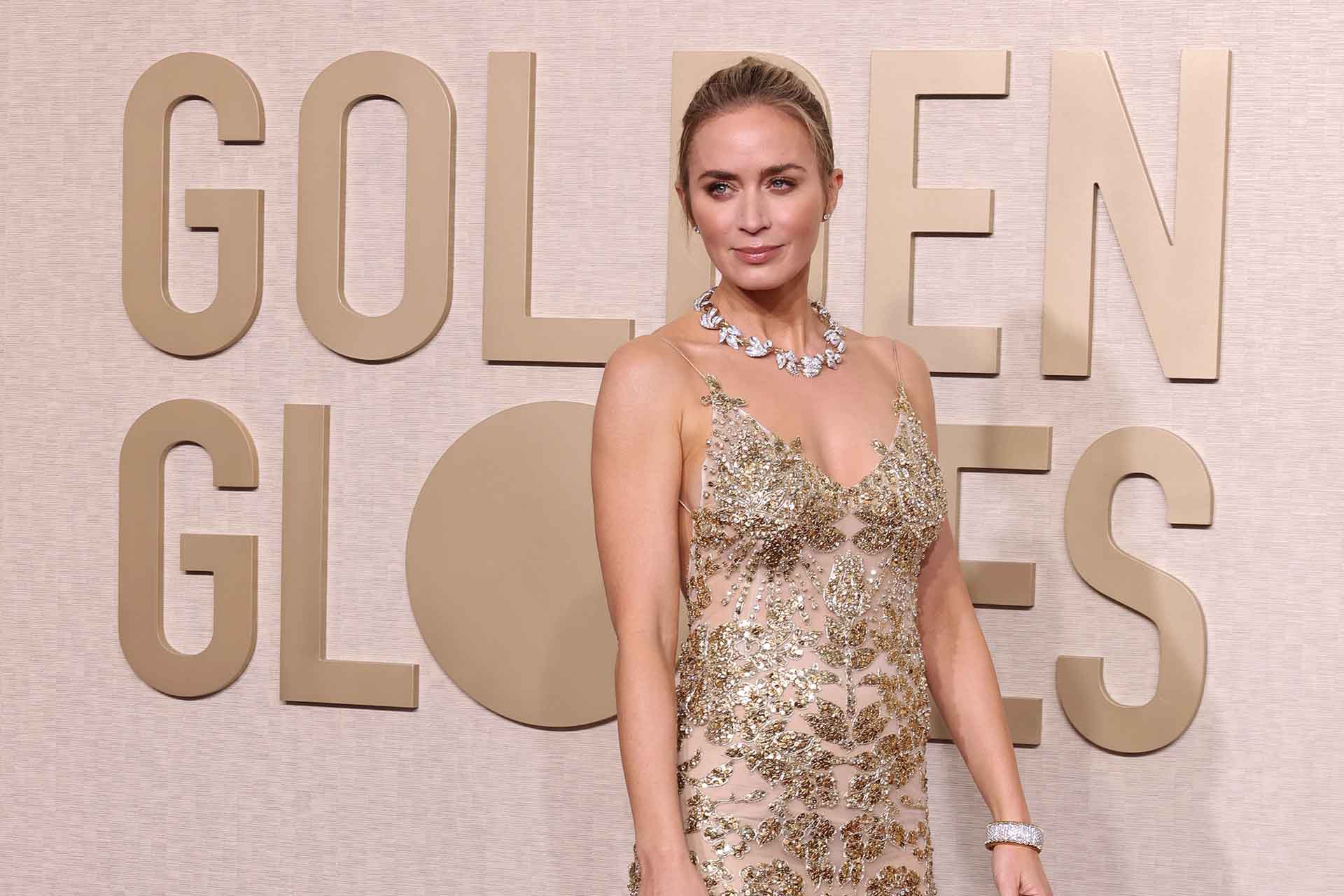 Emily Bunt in a gold sparkly dress at the Golden Globes.