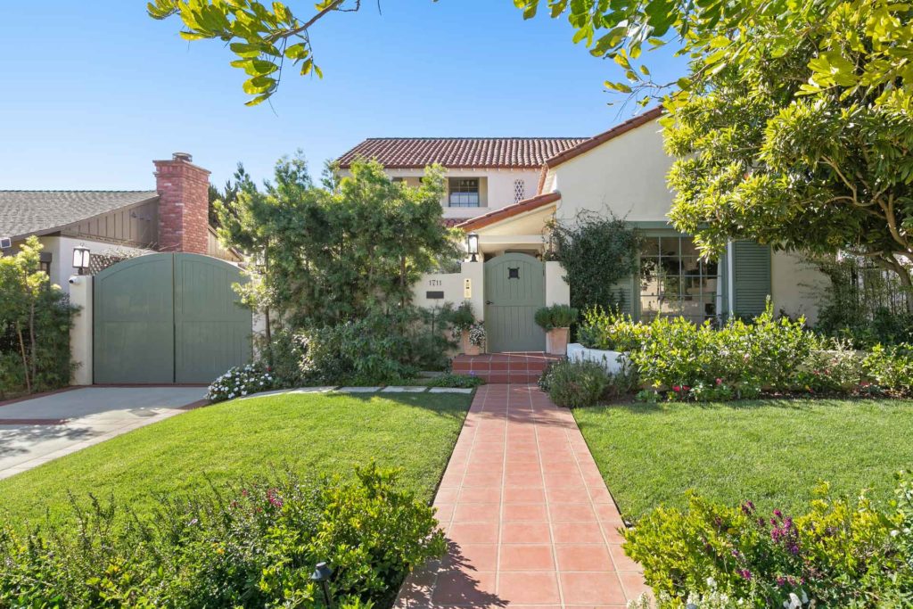 Exterior of Emma Stone's Spanish-style home with grassy front yard