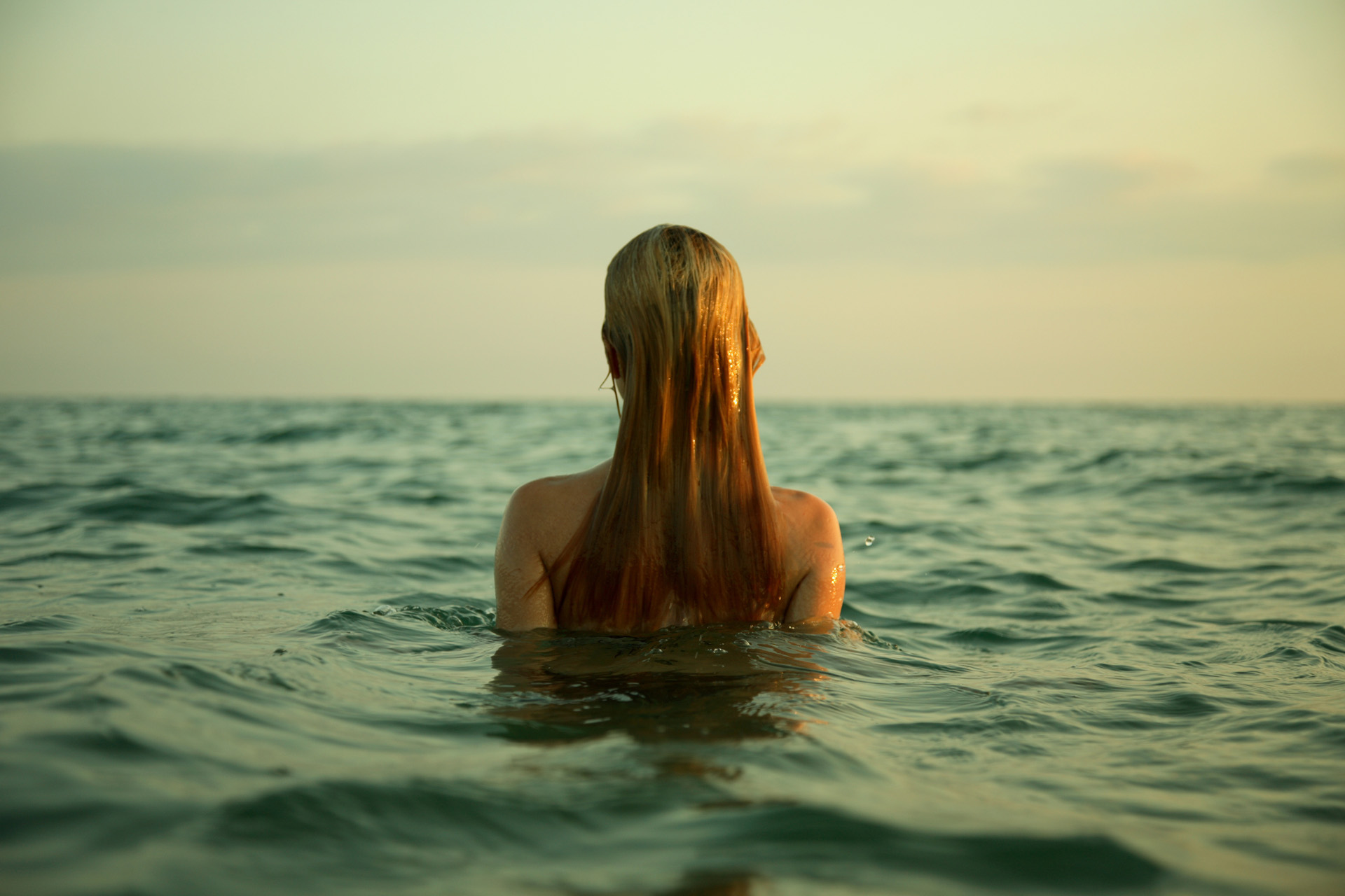 A woman swimming naked in the sea