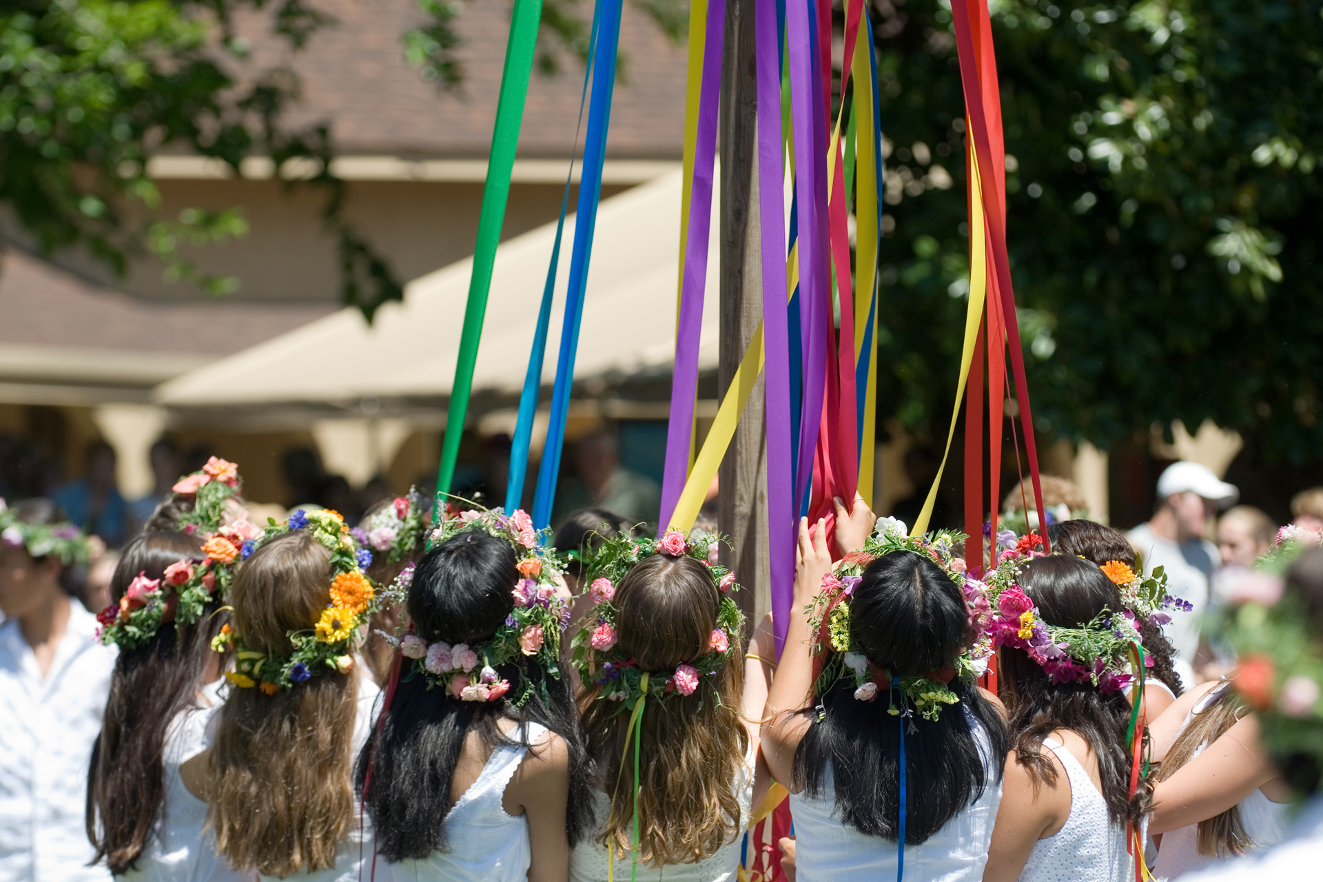 Maypole dancers gather around the Maypole