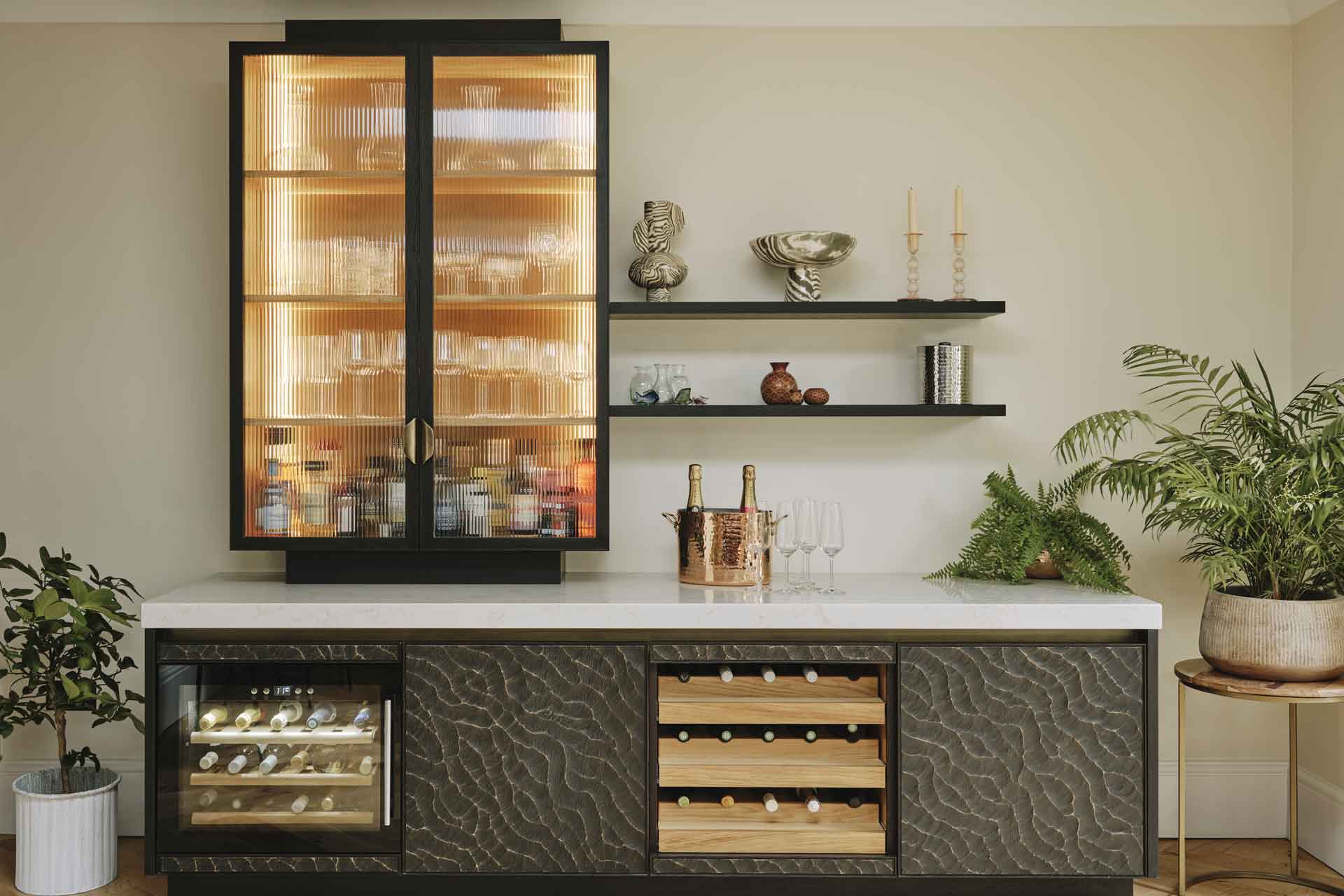 Brown kitchen cabinet with textured doors and in-built wine storage.