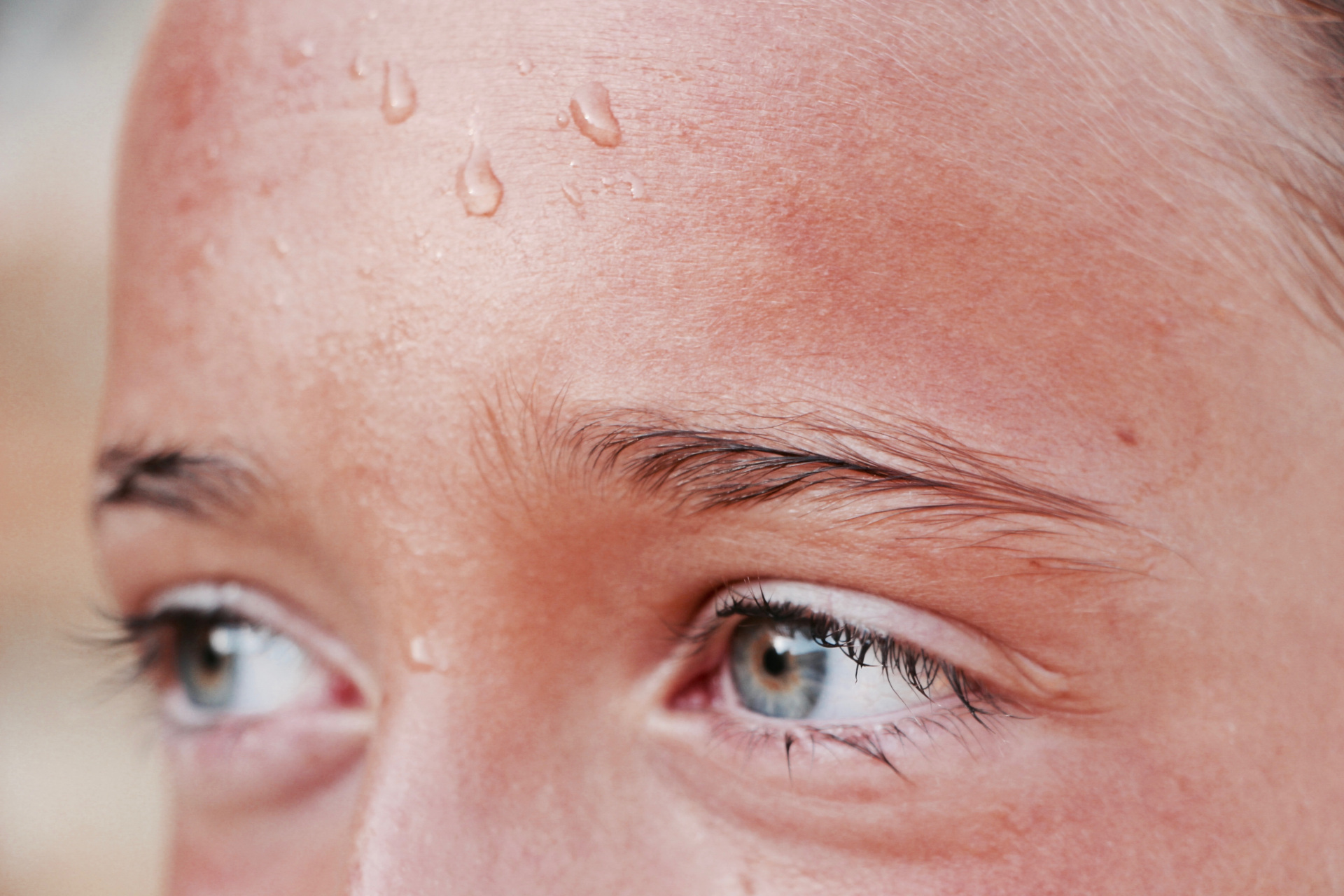 Close up of eyes with sweat on forehead