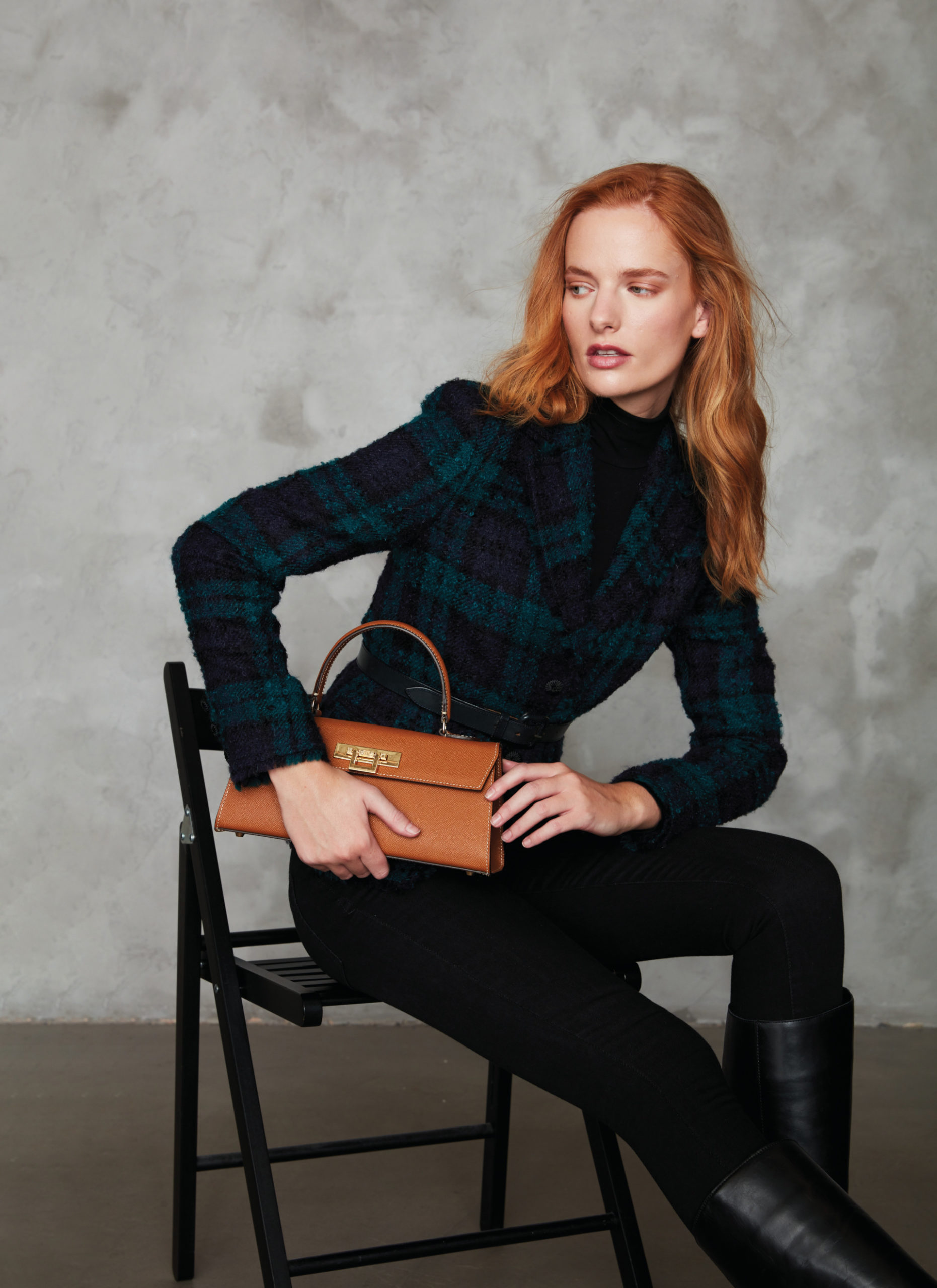 Woman sat on chair with brown bag