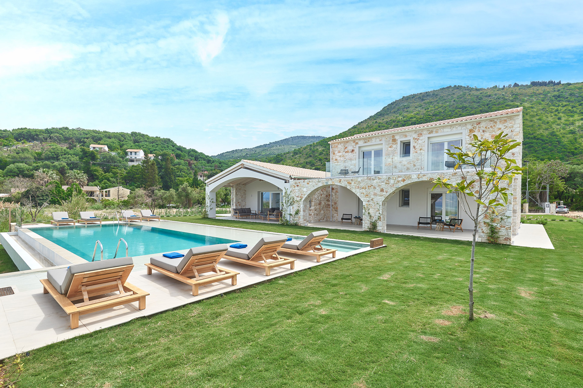 A large villa overlooking a swimming pool