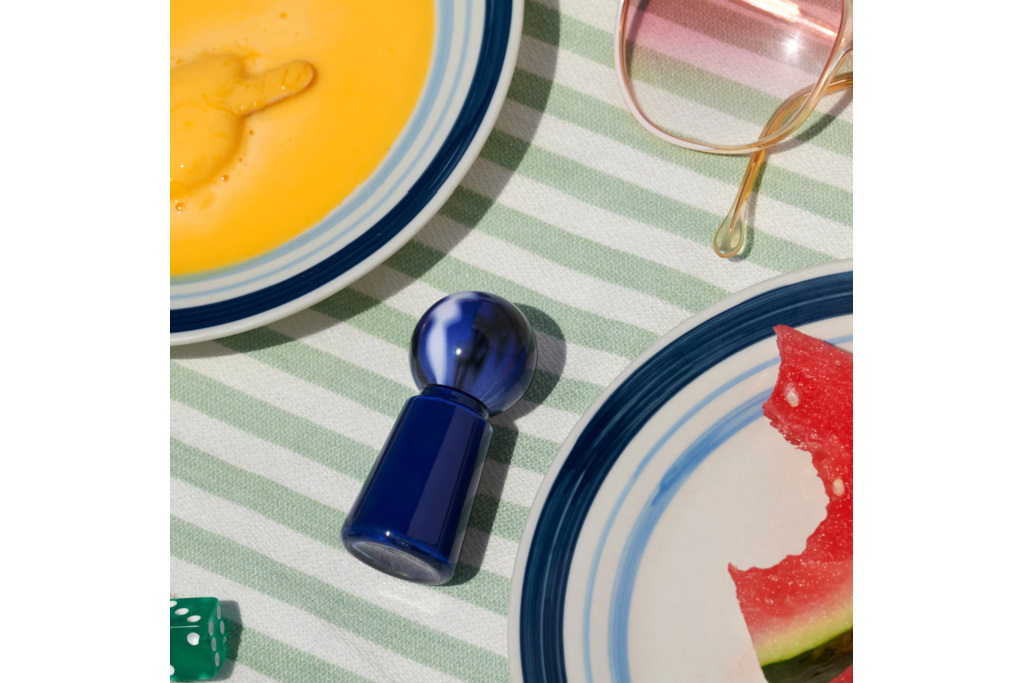 Nail varnish on table surrounded by plates