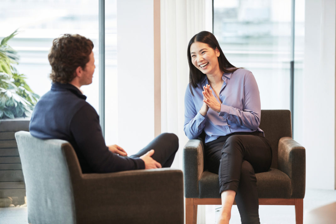 Woman on man sat on chairs together