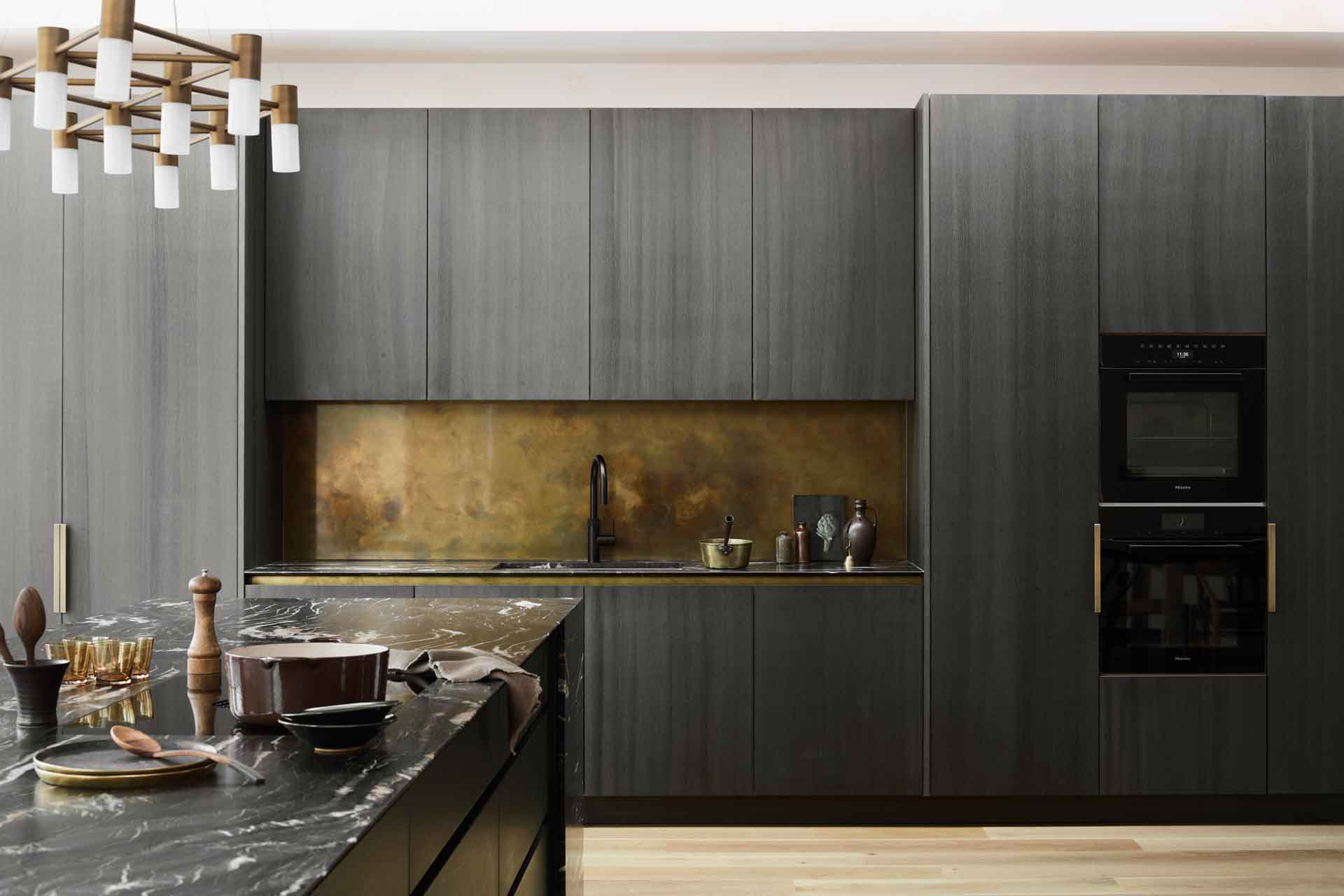 Kitchen with black cabinets and gold accents