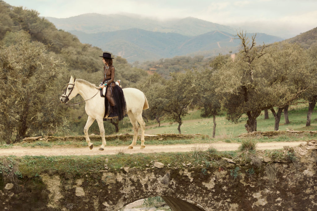 Model on a white horse photographed at Caballo de Hiero in Spain
