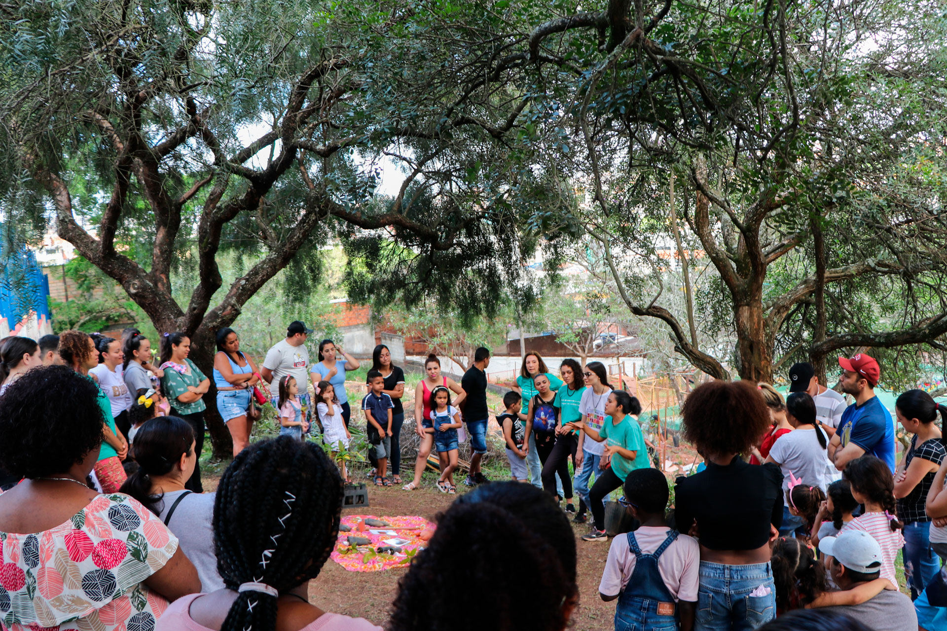 A group of people gathered in a circle in a forest