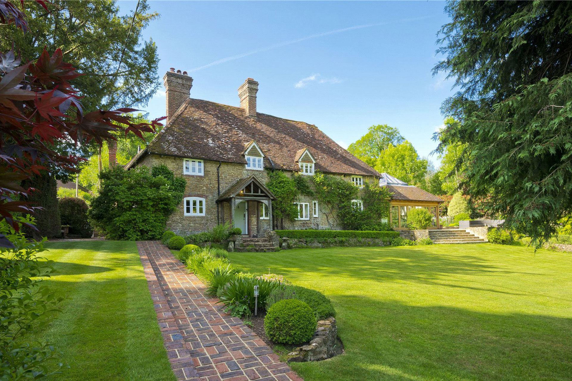 Brick country home with lawn.