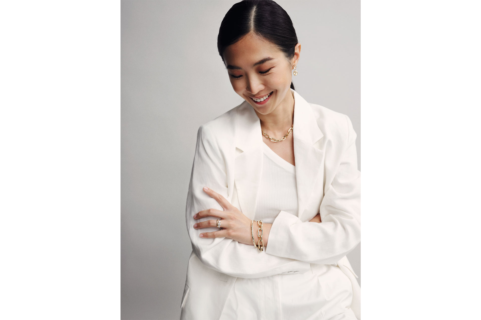 Woman wearing white top and white blazer and Sophie Breitmeyer jewellery